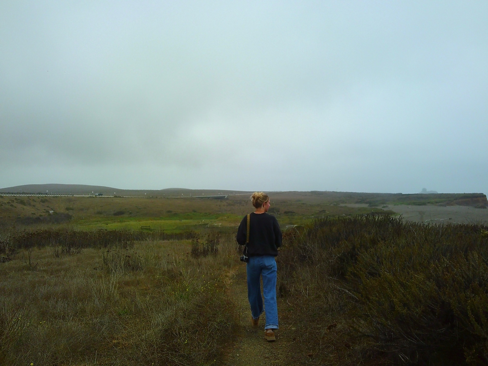 Maddie walking into the landscape with camera